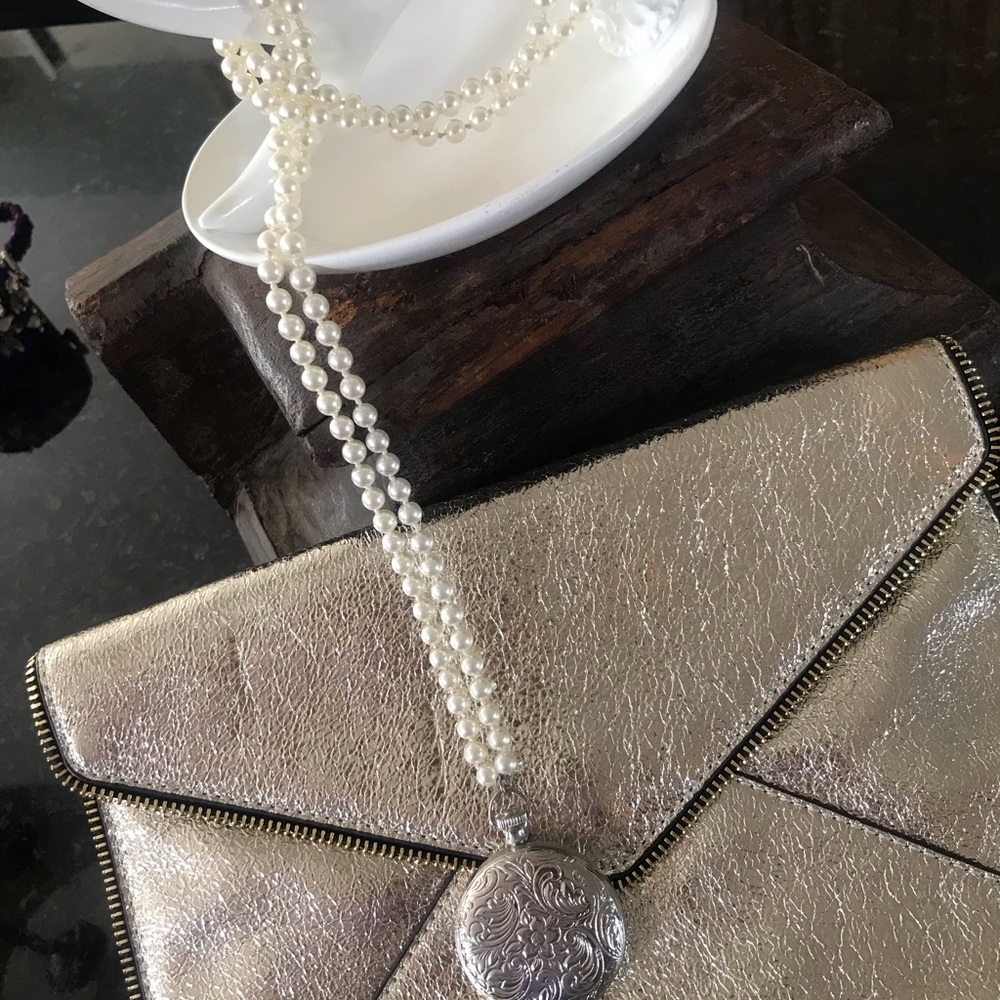 Long pearl necklace with large locket
